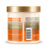 Back view of a cosmetic jar with text and a gold lid on an orange background