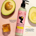 Camille Rose Fresh Curl Revitalizing Hair Smoothie with avocado and castor seed oil on a pink background