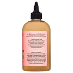 Bottle of hair product with a pink label on a white background