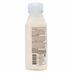 Back view of a white bottle with a label on a white background