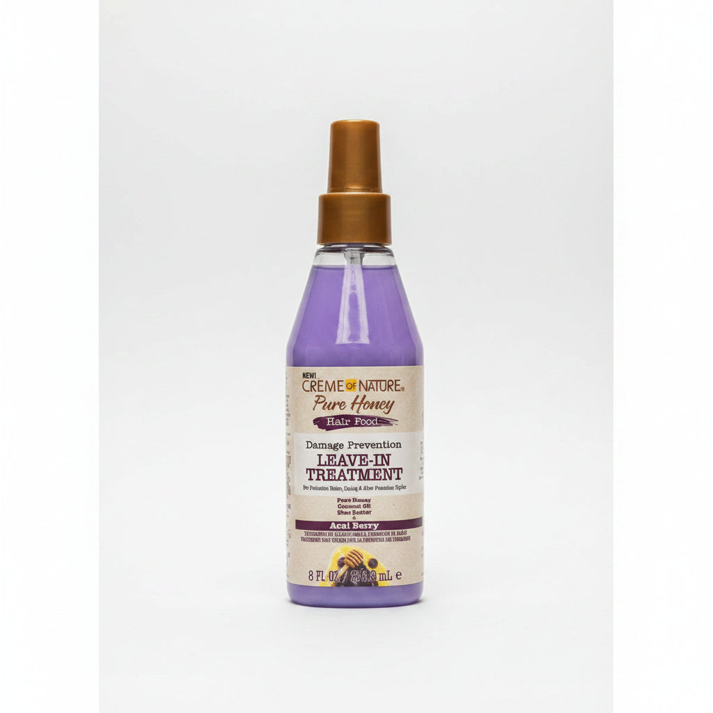 Bottle of Creme of Nature Pure Honey Damage Prevention Leave-In Treatment on a white background