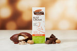 A tall rectangular box of Palmers Cocoa Butter Formula Bust Cream on a plain white background. The packaging is primarily white with orange, brown, and green sections, featuring product text and a line drawing of a female bust.