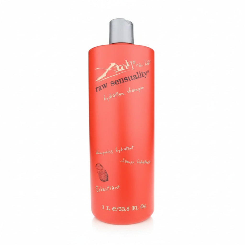 Red shampoo bottle with silver cap on a white background