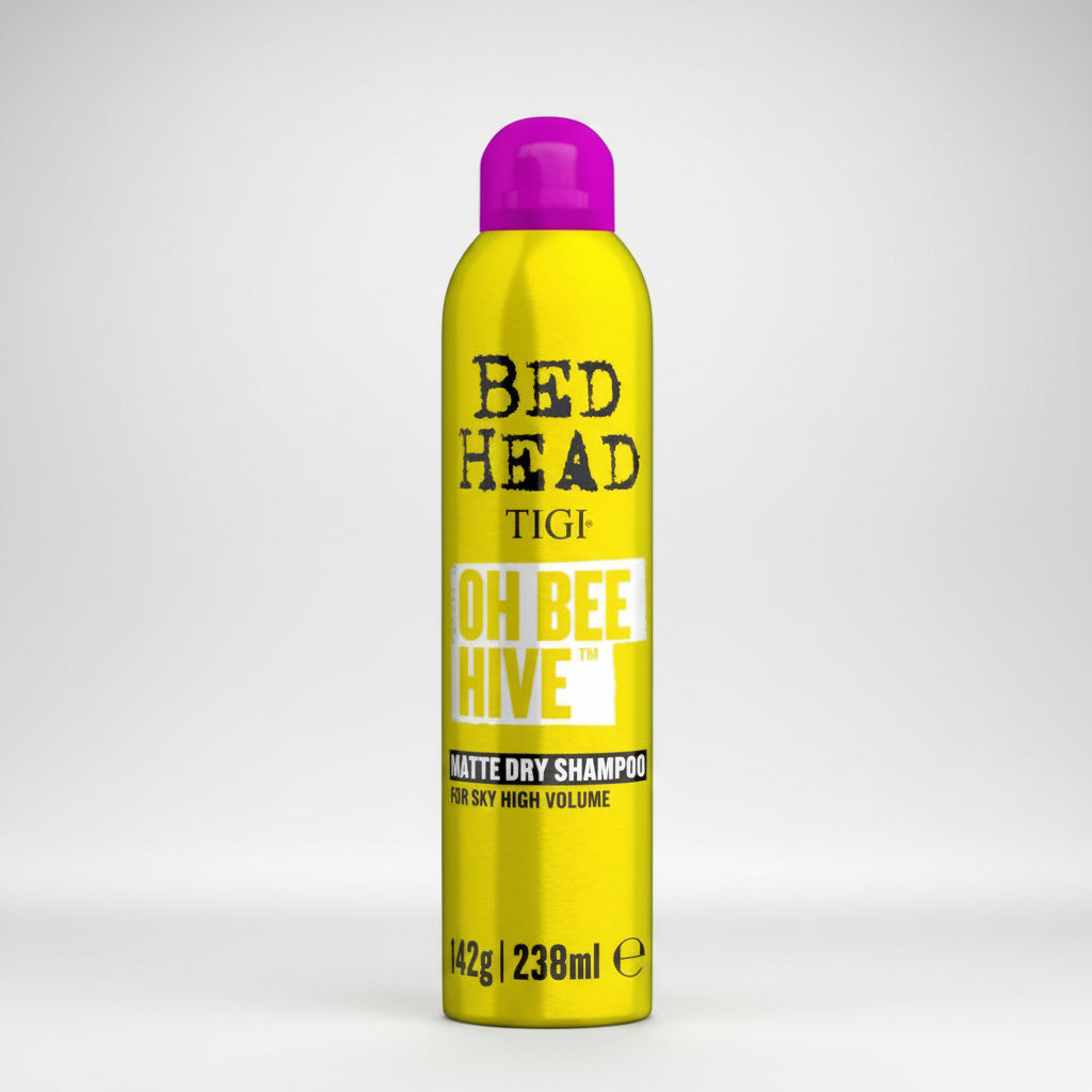 Yellow bottle of TIGI Bed Head Oh Bee Hive dry shampoo on a white background